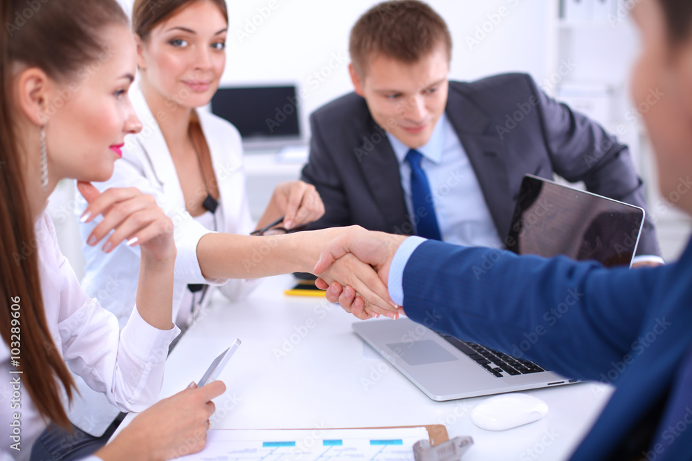 Business people shaking hands, finishing up a meeting, in office Business people shaking hands, finishing up a meeting, in office