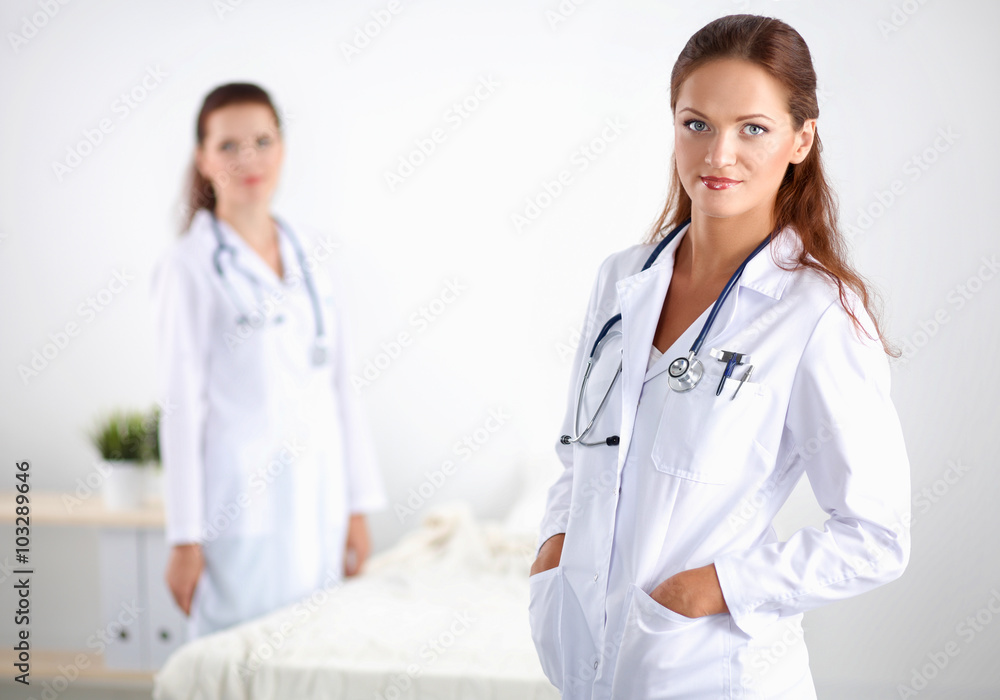 Smiling female doctor with a folder in uniform standing at hospital Smiling female doctor with a folder in uniform standing at hospital