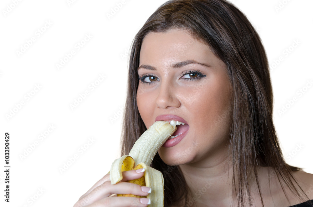 Cute brunette lady wear black shirt, holding and eating a peeled banana Cute brunette lady wear black shirt, holding and eating a peeled banana