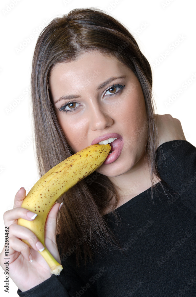 Cute brunette lady wear black shirt, holding and biting a banana Cute brunette lady wear black shirt, holding and biting a banana