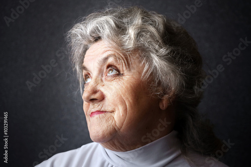 Thoughtful granny face on a dark background