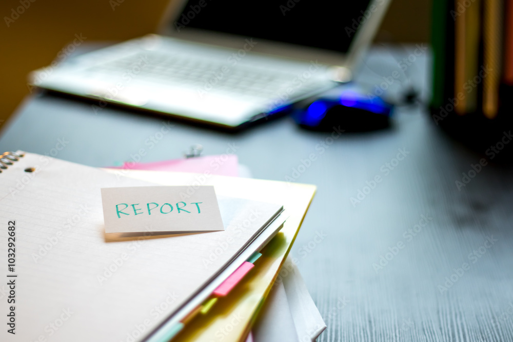 Report; Stack of Documents and Laptop at working Desk. Report; Stack of Documents and Laptop at working Desk.