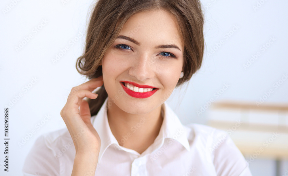 Attractive young businesswoman sitting in the office Attractive young businesswoman sitting in the office