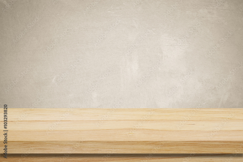 Empty wooden table over grunge cement wall background Empty wooden table over grunge cement wall background