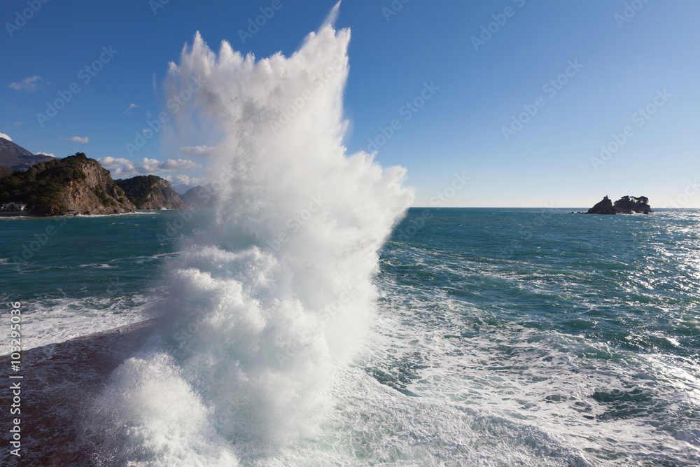 Fototapeta premium Stone breakwater with breaking waves.