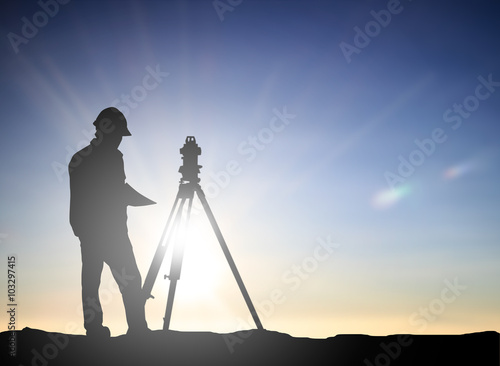 silhouette engineer looking Loaders and trucks in a building sit