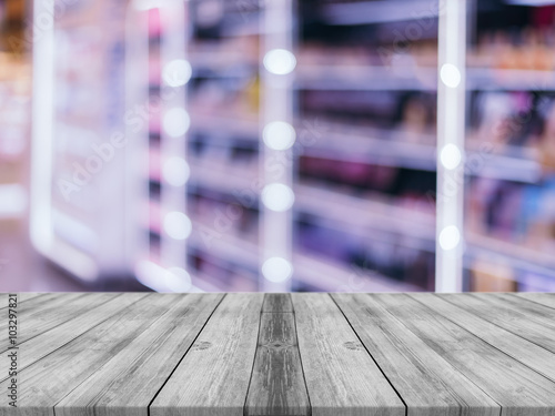 Wooden board empty table in front of blurred background. Perspective grey wood over blur store in mall - can be used for display or montage your products. vintage filtered image.