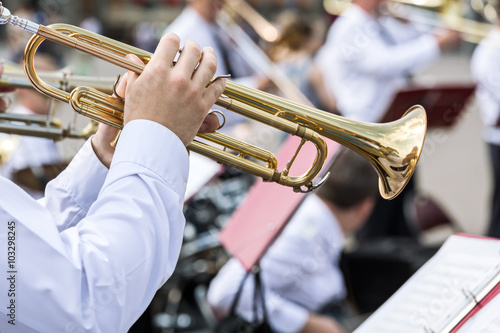 musician of military orchestra plays his gold trumpet