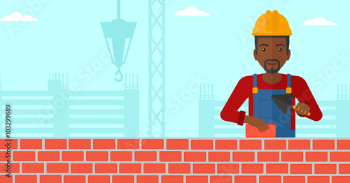 Bricklayer with spatula and brick.