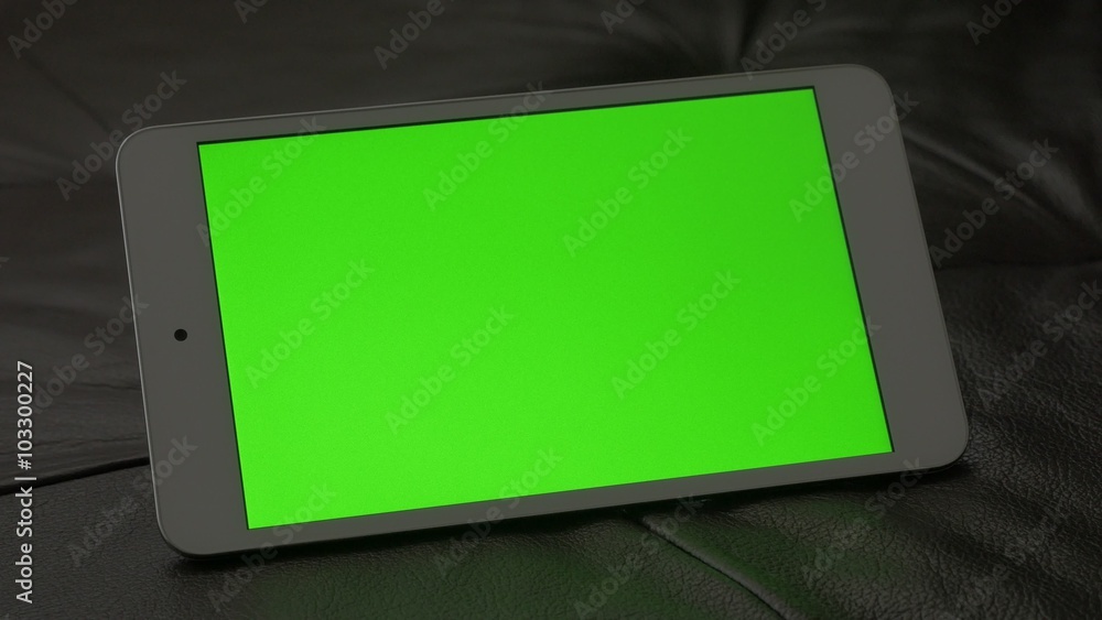 Green screen presented on PC tablet computer 4K 2160p UltraHD footage - PC silver tablet on leather sofa 4K 3840X2160 UHD video Green screen presented on PC tablet computer 4K 2160p UltraHD footage - PC silver tablet on leather sofa 4K 3840X2160 UHD video