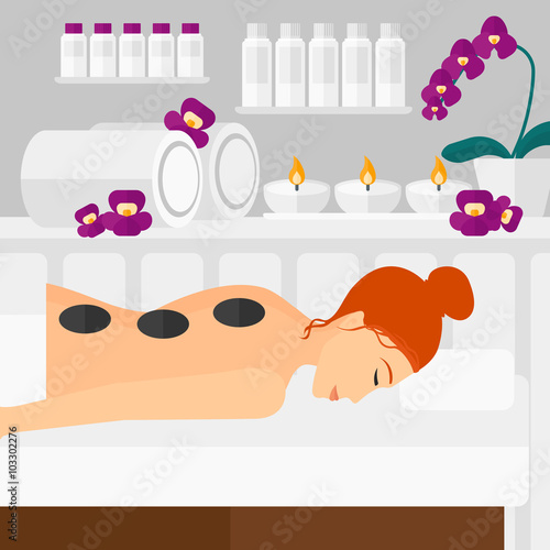Woman getting stone therapy.