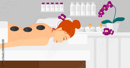 Woman getting stone therapy.