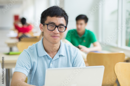Student using a laptop in the library.