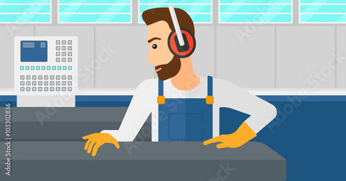 Man working on steel-rolling mill.