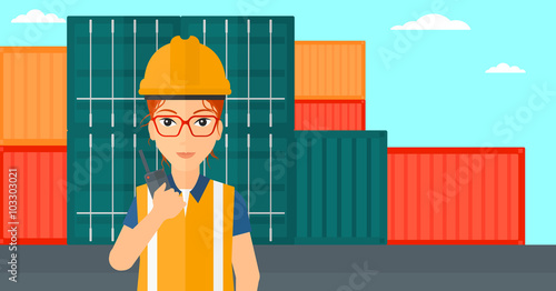 Stevedore standing on cargo containers background.