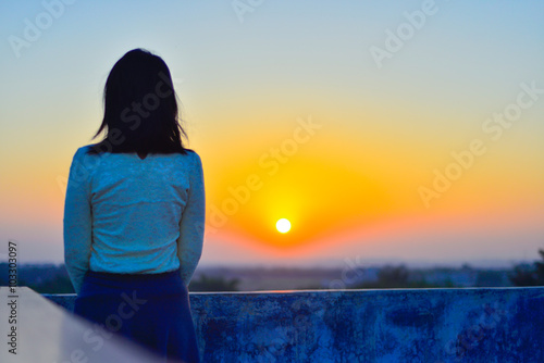 Young woman in rural rooftop enjoy the sunset