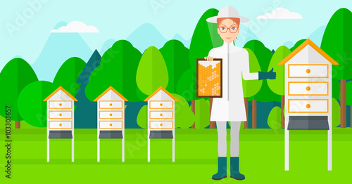 Bee-keeper at apiary.