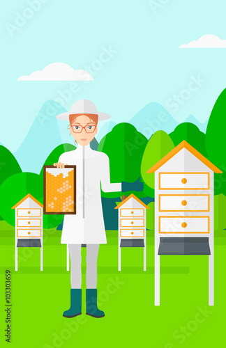 Bee-keeper at apiary.
