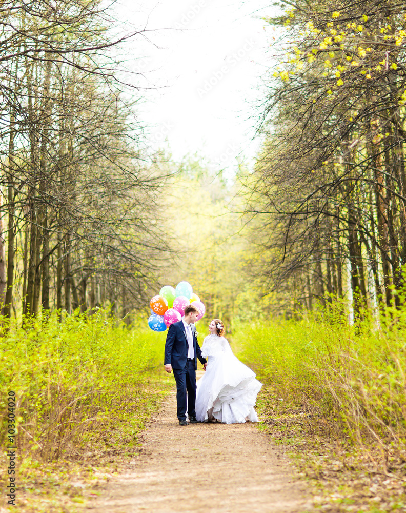 Couple of bride and groom with balloons, outdoor Couple of bride and groom with balloons, outdoor