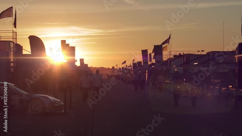 SEBRING, FLORIDA - CIRCA MARCH 2013: Sunset falling on the racing cars tent while fans visit them during the 12 Hours of Sebring at Sebring International Raceway in Sebring, FL.