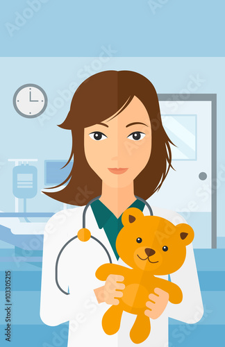 Pediatrician holding teddy bear.