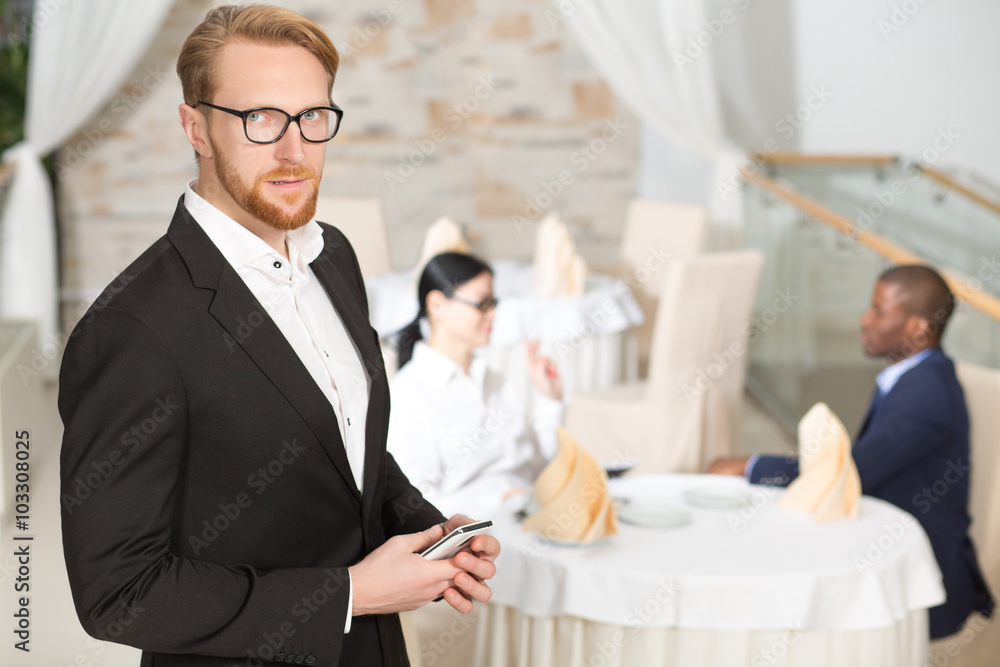 Businessman with mobile phone in restaurant Businessman with mobile phone in restaurant