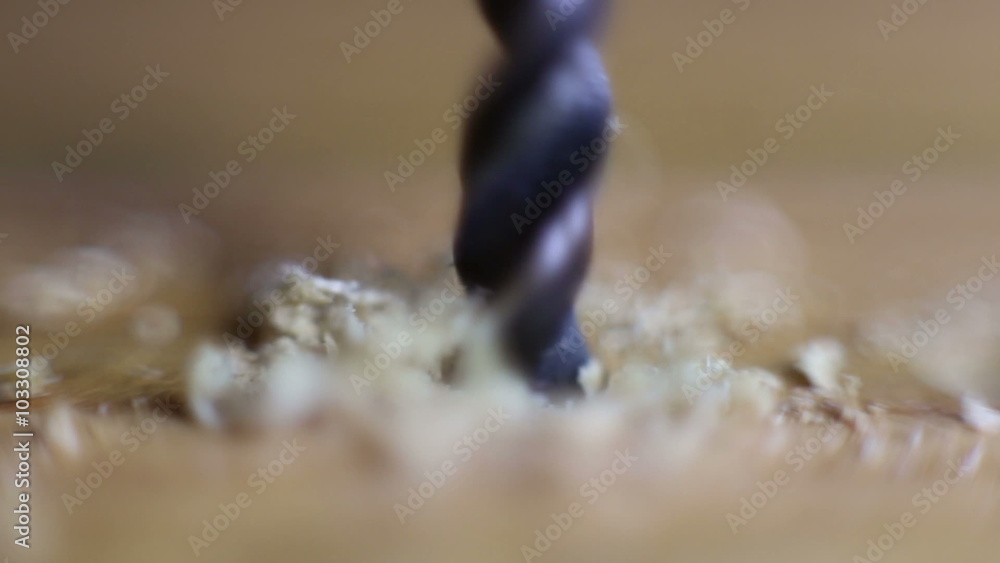 The drill bit is drilling a hole in wood, flying wood chips, man blows off chips, super macro
The drill bit is drilling a hole in wood, flying wood chips, man blows off chips, super macro