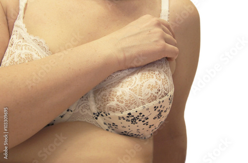 Woman breast in the white bra isolated on the white background photo