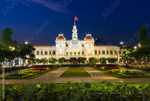 People are walking and taking pictures in front of the City Hall building, Ho Chi Minh City, Vietnam on February 14, 2016.