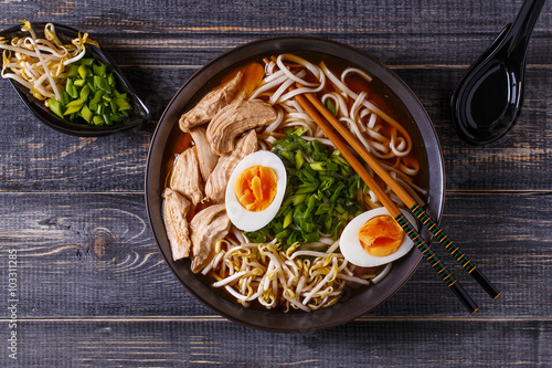 Japanese ramen soup with chicken, egg, chives and sprout.