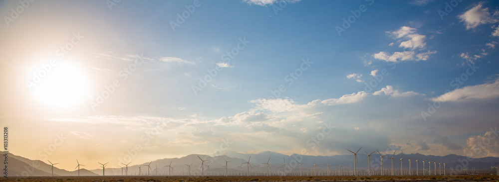Windmills Renewable Energy Turbine Farm. A Panorama of an Energy Wind Turbine Farm providing alternative energy in a desert environment. Windmills Renewable Energy Turbine Farm. A Panorama of an Energy Wind Turbine Farm providing alternative energy in a desert environment.