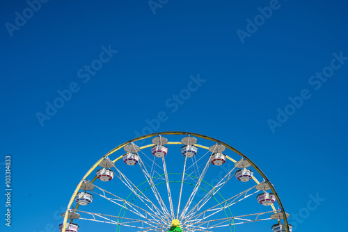 Carnival Ferris Wheel with Clean Skies with Empty Space. Close up shot of half of a ferris wheel in Coachella California.