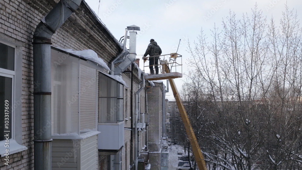 Strong man removing ice dams Strong man removing ice dams