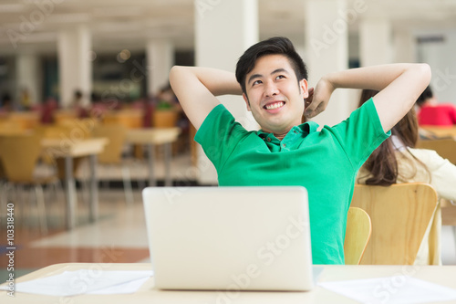 Student with a laptop in the library.