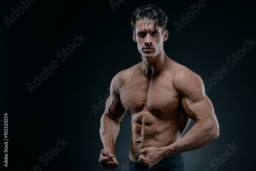 Muscular athletic bodybuilder fitness model posing