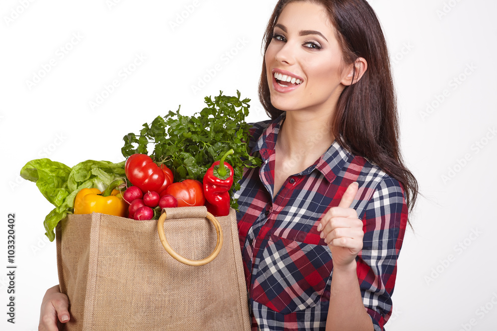 Young woman with a grocery shopping bag. Isolated on white backg Young woman with a grocery shopping bag. Isolated on white backg