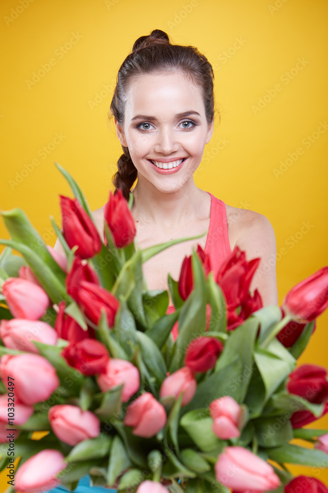 Young beautiful woman studio portrait with tulip flowers Young beautiful woman studio portrait with tulip flowers