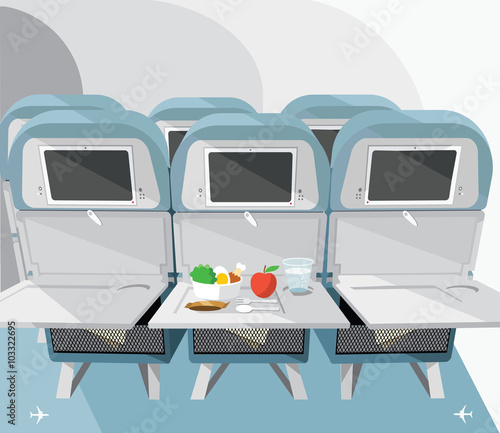 Airplane seats with opened tables, food and drink