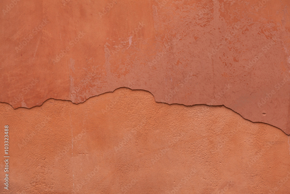 Obraz premium Old terracotta painted stucco wall with cracked plaster. Backgro