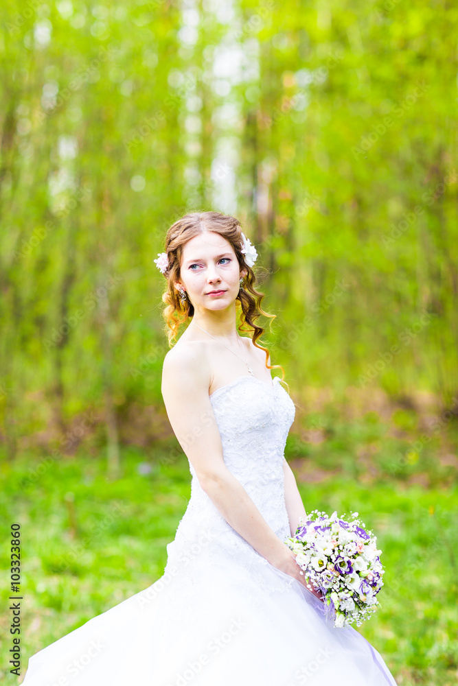 Beautiful bride outdoors in a forest.