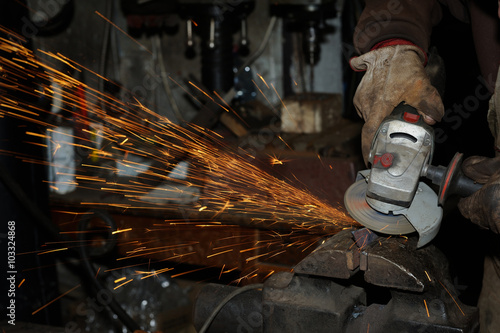 Angle grinder cutting steel with sparks