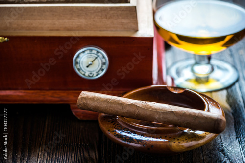 Cigar with glass of cognac and humidor © marcin jucha