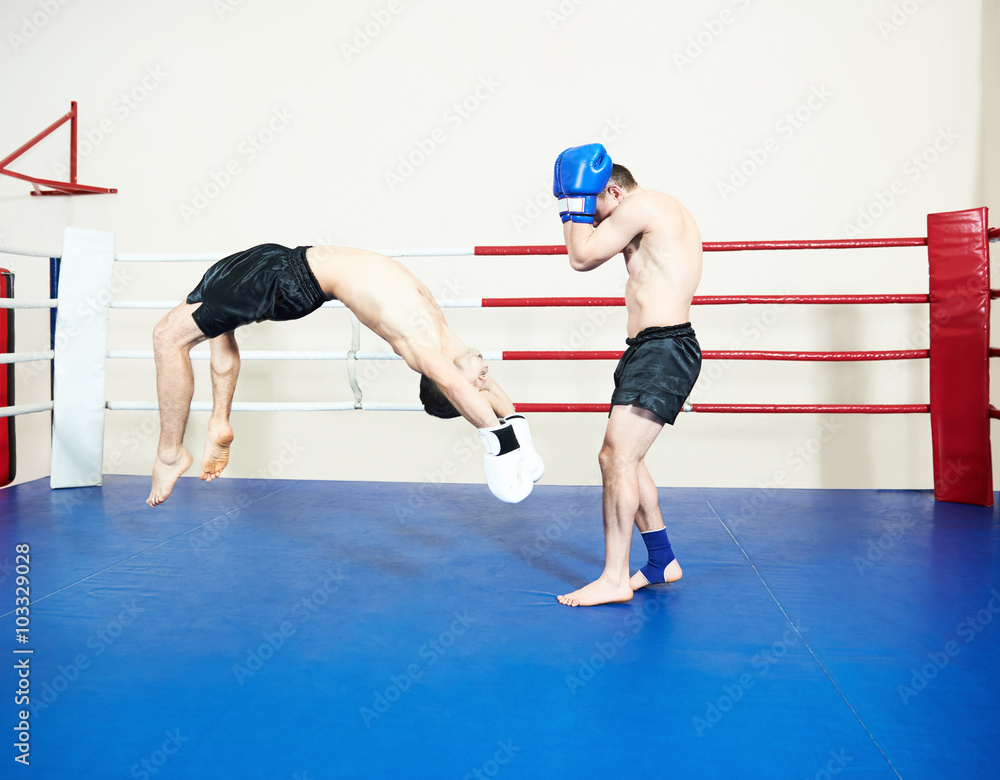 Muay thai sportsman fighting at boxing ring