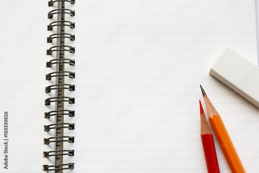 Blank notebook with pencil, red pencil, and eraser on white background. Blank notebook with pencil, red pencil, and eraser on white background.