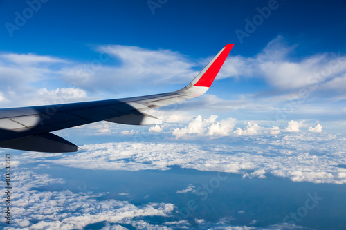 Clouds and sky as seen through window of an aircraft