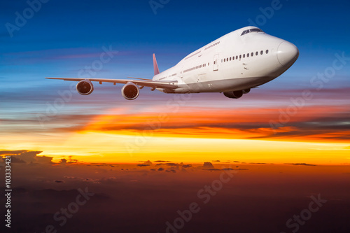 Airplane in the sky at sunrise