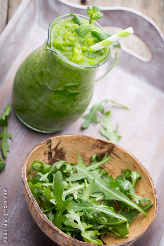 Rucola smoothie, on the grey background. Rucola smoothie, on the grey background.
