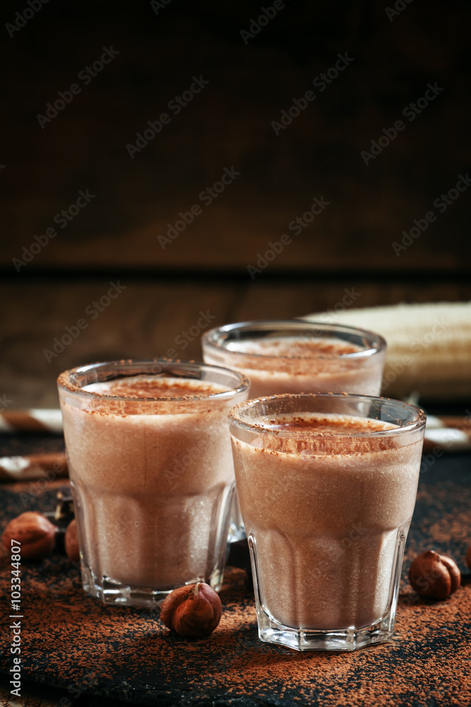 Banana chocolate smoothie with nuts, dusted with a powder, healt Banana chocolate smoothie with nuts, dusted with a powder, healt