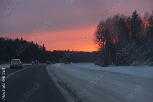 cars in the road, winter at sunset