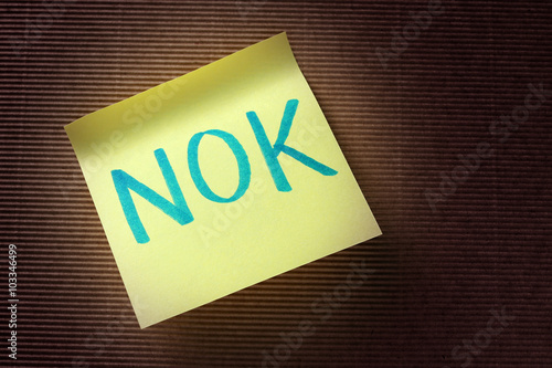 NOK (Norwegian Krone) acronym on yellow sticky note